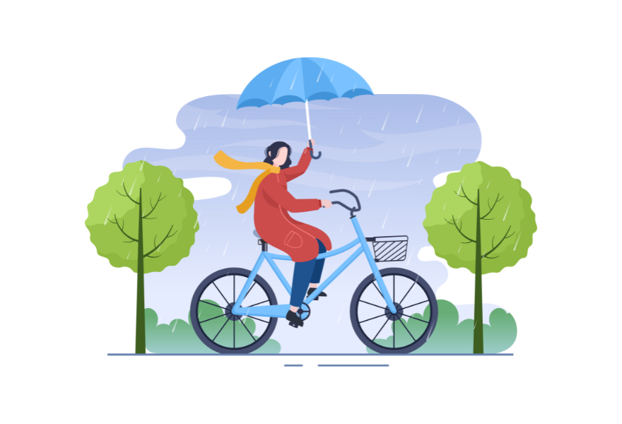 雨の日に自転車にのる女性